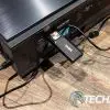 The QS01 Android TV dongle is a bit of a mess when plugged into the BenQ V7050i 4K UST laser TV projector